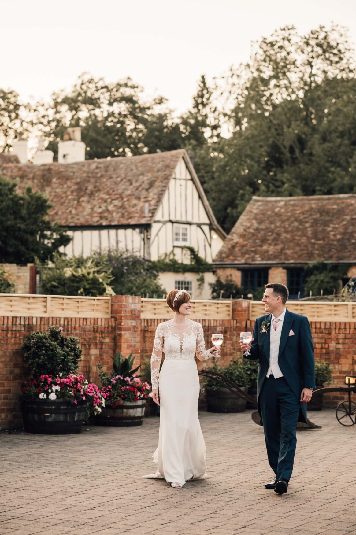 Newlyweds in the courtyard at Bassmead Manor Barns,