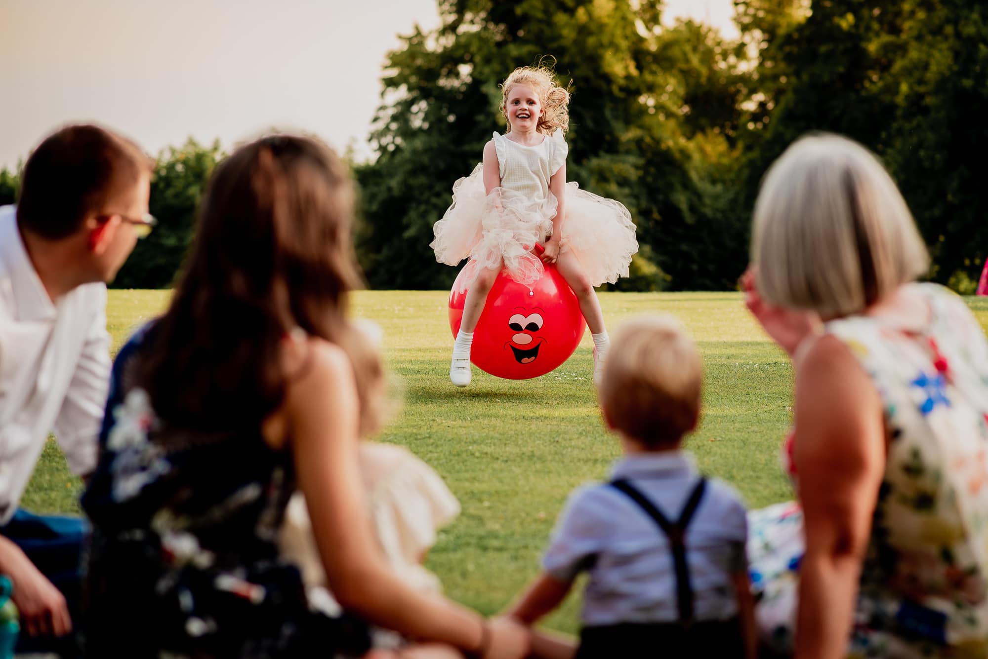 Girl on a space hopper at Holdenby House Wedding
