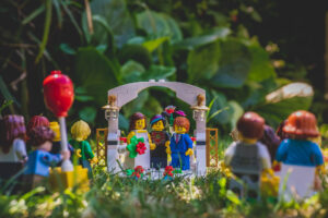 Lego Bride and Groom look back and smile at their wedding guests