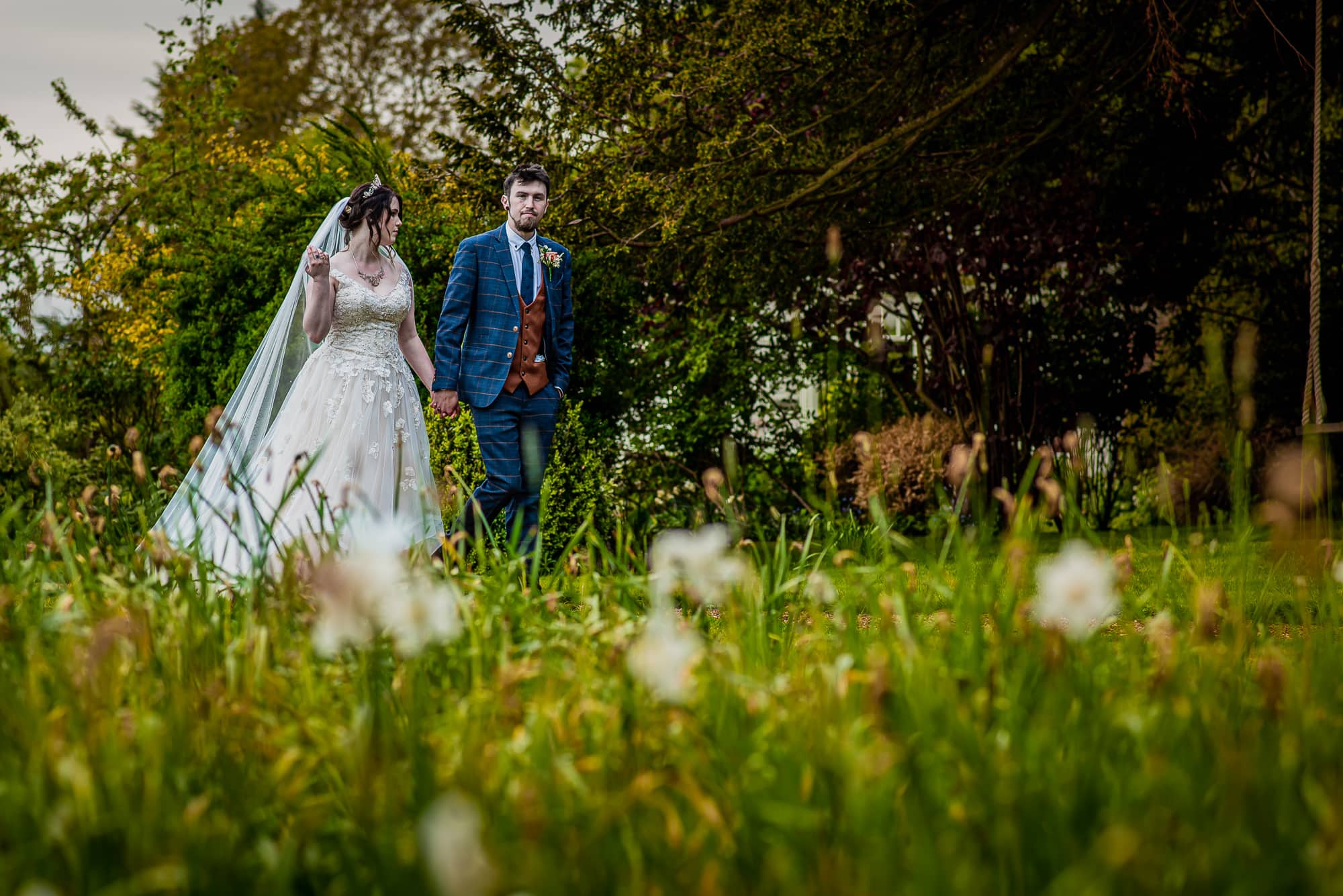 Bride and groom walking the grounds of Stradsett Hall Wedding venue in Cambridgehire