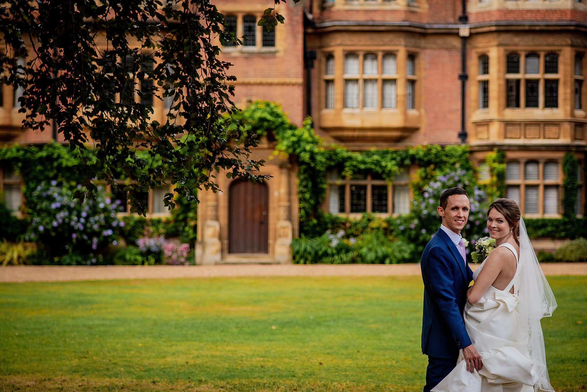 Newlyweds in the grounds of Trinity Hall college in Cambridge